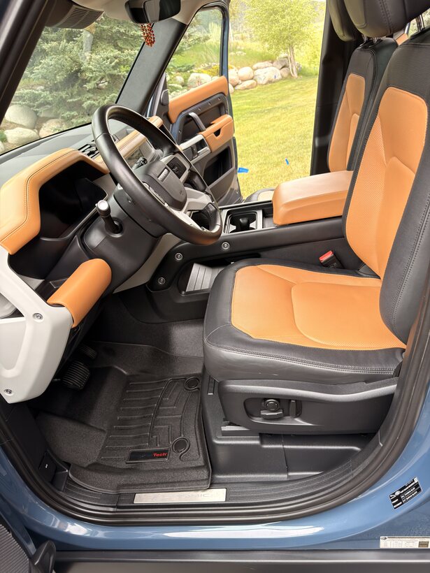 Tan leather front seats and steering wheel after an interior detail