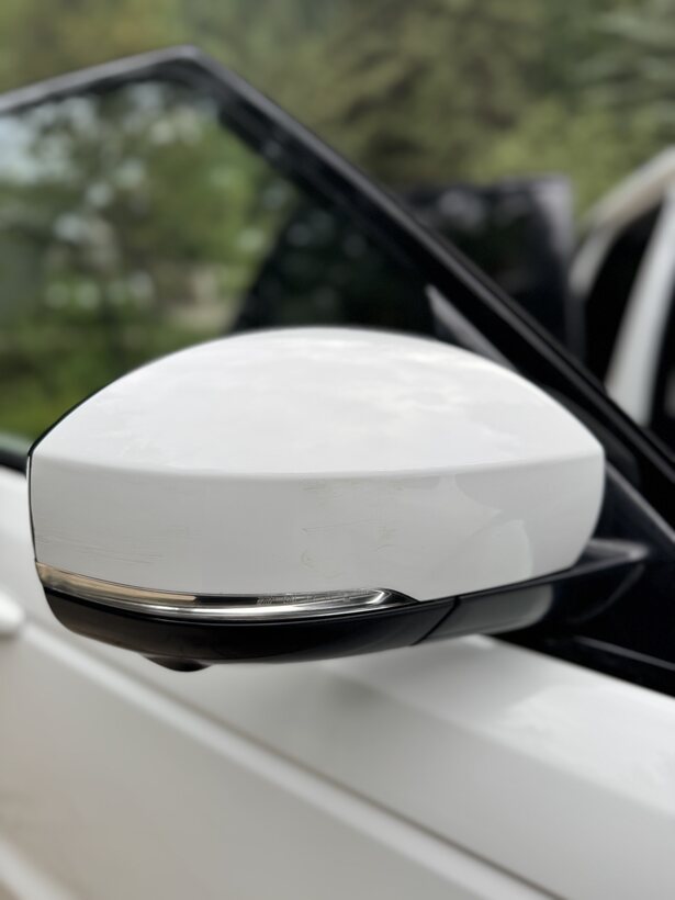 Polished white side mirror closeup