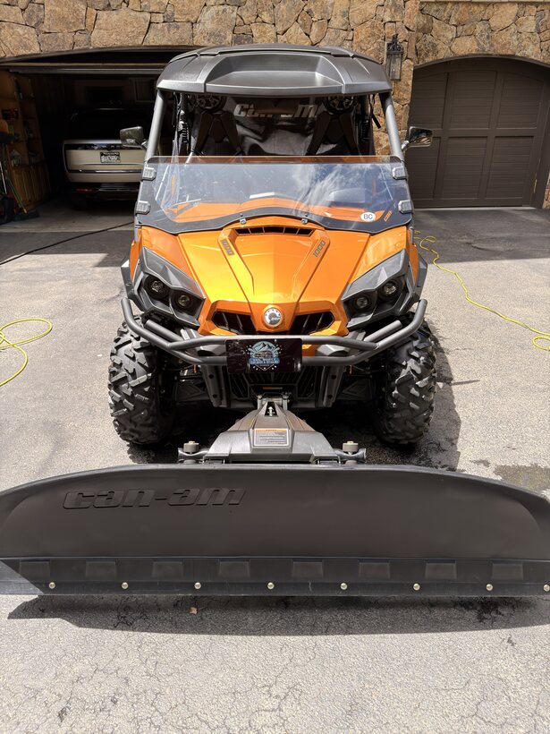 Orange off-road UTV with snow plow cleaned up
